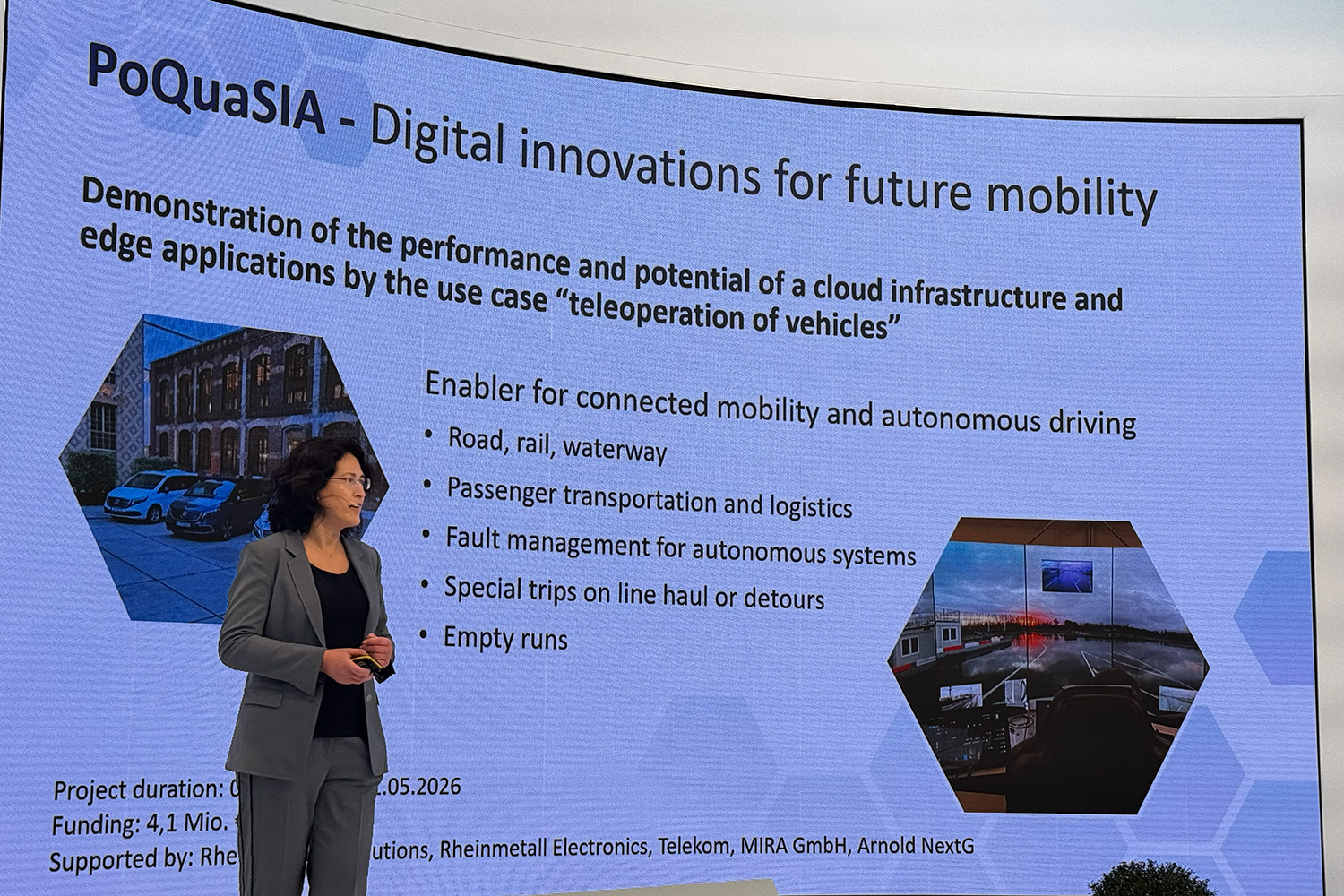 person standing in front of a presentation for the project PoQuaSIA